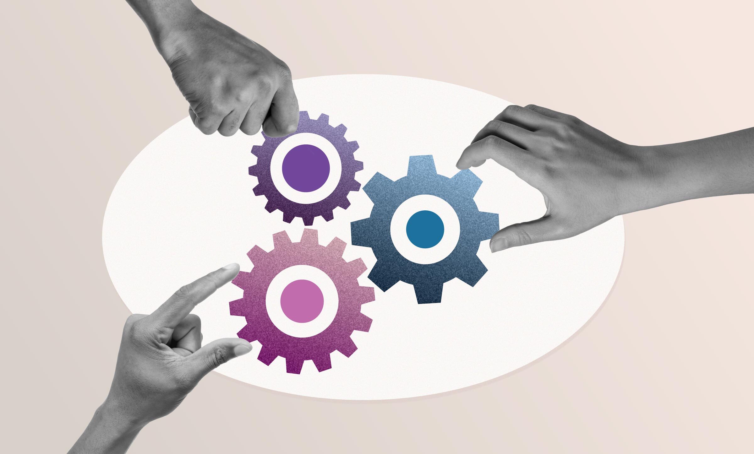 Three hands place three different sized gears close together.