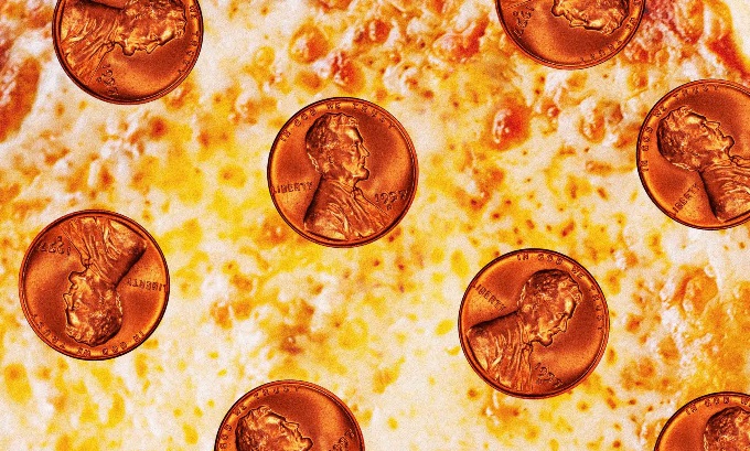 A close-up view of greasy cheese pizza with pennies in the place of pepperonis.