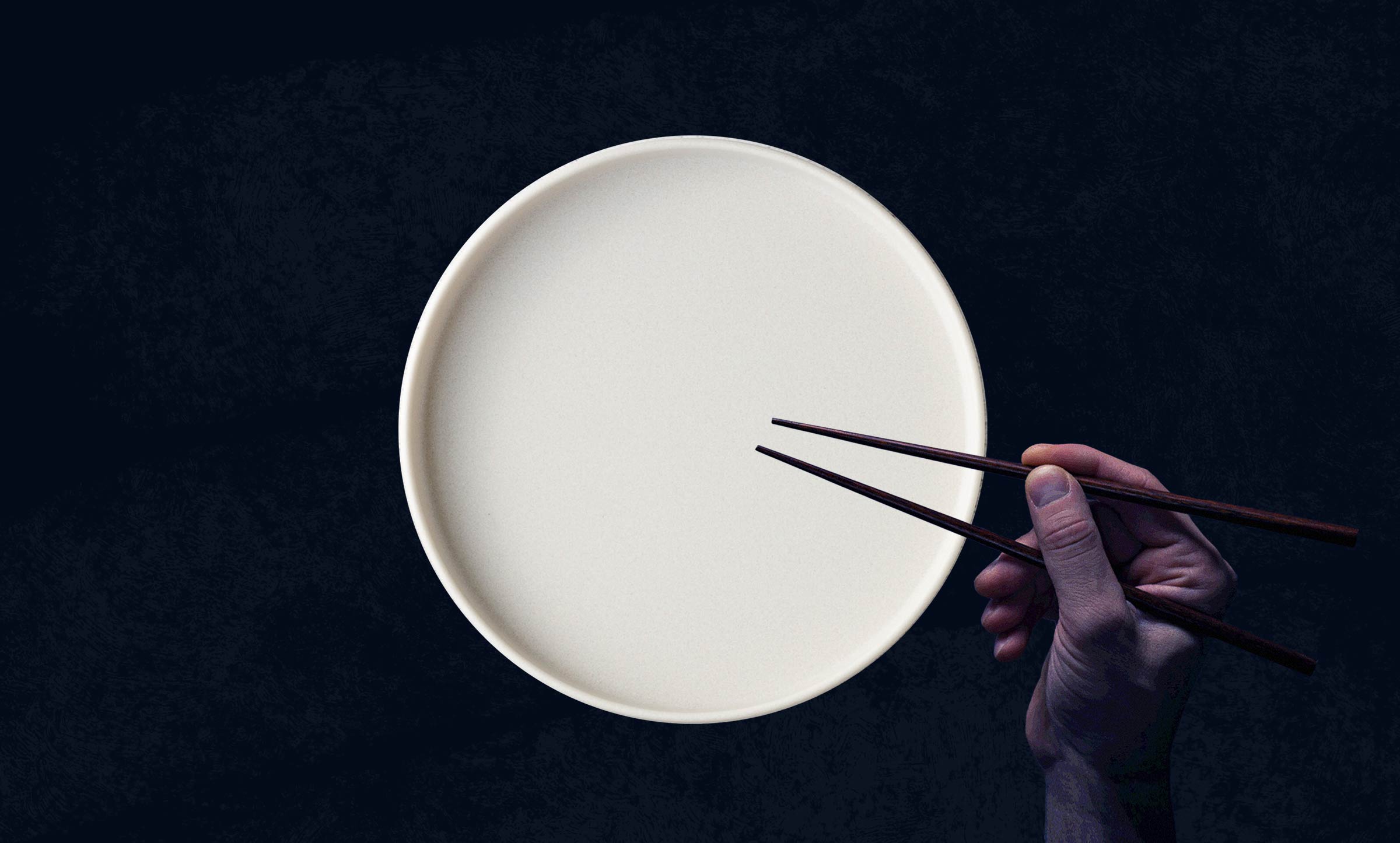 A white, empty plate with a waiting hand holding chopsticks.