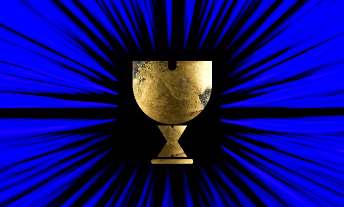 The letters U and X in gold, stacked to imply the shape of a Holy Grail, with a blue abstract background.