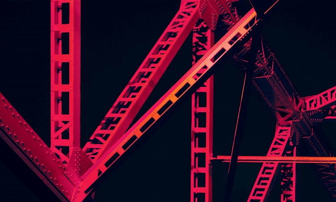 Bright red scaffolding on a black background that keeps connecting to itself and never seems to end.