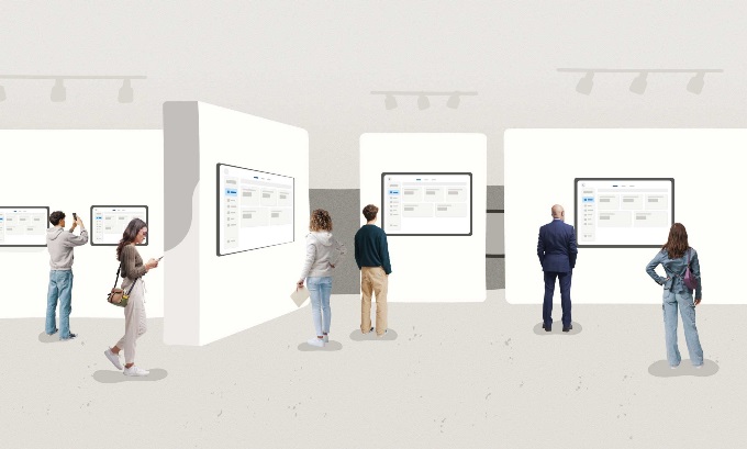 People walk around a museum, looking at displays of similar looking user interfaces.